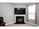 Close-up of fireplace flanked by curtains and a large wall-mounted television at 1312 Donald Pass, Greenwood, IN 46143