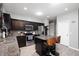 Well-equipped kitchen with stainless steel appliances, dark cabinets, and a functional island seating at 1312 Donald Pass, Greenwood, IN 46143