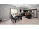 Modern eat-in kitchen features dark cabinets, stainless appliances, a dining table, and an island with bar seating at 1312 Donald Pass, Greenwood, IN 46143