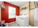 Laundry room with modern washer and dryer, storage shelves, and neutral paint at 1312 Donald Pass, Greenwood, IN 46143