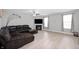 Spacious living room with hardwood floors, fireplace, recessed lights, ceiling fan and a comfy sectional at 1312 Donald Pass, Greenwood, IN 46143