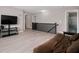 Second story living room with flat screen TV, stairs, and an adjacent bathroom at 1312 Donald Pass, Greenwood, IN 46143