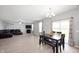 Bright and airy living room and dining space boasts hardwood floors, fireplace, and sliding glass doors at 1312 Donald Pass, Greenwood, IN 46143