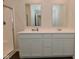 Bathroom with dual sink vanity, framed mirrors, and a glass shower at 1351 Byron St, Greenfield, IN 46140