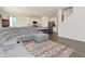 Spacious open-concept living room with gray sofa, modern kitchen and hardwood flooring at 1351 Byron St, Greenfield, IN 46140