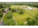 Expansive property with lush pastures, mature trees, and outbuildings, captured from an aerial perspective at 16714 Oak Rd, Westfield, IN 46074