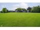 Expansive property featuring a well-manicured lawn, mature trees, outbuildings, and a charming gazebo at 16714 Oak Rd, Westfield, IN 46074