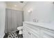 Bathroom with white vanity, white countertop, chrome fixtures, and shower with patterned curtain at 16714 Oak Rd, Westfield, IN 46074