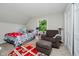 Cozy bedroom featuring a window, comfortable armchair with ottoman, and playful rug at 16714 Oak Rd, Westfield, IN 46074
