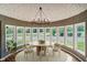 Charming dining room with a vaulted ceiling and a wall of windows showcasing the property's landscape at 16714 Oak Rd, Westfield, IN 46074