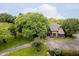 Aerial view of a unique home with a stone and wood exterior, complemented by mature trees and landscaping at 16714 Oak Rd, Westfield, IN 46074