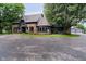 Charming home with a stone and wood exterior, complemented by a circular window and well-manicured lawn at 16714 Oak Rd, Westfield, IN 46074