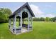 Quaint gazebo with decorative trim, planter boxes, and views of the expansive, well-manicured yard at 16714 Oak Rd, Westfield, IN 46074