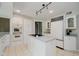 Contemporary kitchen with a cooktop island, white cabinets and stainless steel appliances at 16714 Oak Rd, Westfield, IN 46074