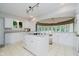 Stylish kitchen features white cabinetry, a cooktop island, and views to the circular dining area at 16714 Oak Rd, Westfield, IN 46074