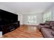 Bright living room showcasing wood floors, a large tv media center, and comfortable sofa with plenty of natural light at 16714 Oak Rd, Westfield, IN 46074