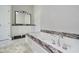 Luxurious bath with marble counters, a modern tub, and a separate vanity at 16714 Oak Rd, Westfield, IN 46074
