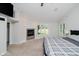 Cozy bedroom boasts a modern fireplace, a ceiling fan, and a comfortable aesthetic at 16714 Oak Rd, Westfield, IN 46074