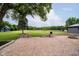 Paver patio overlooking a large, grassy backyard, enhanced by stone retaining walls and mature trees at 16714 Oak Rd, Westfield, IN 46074