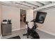 Finished basement space featuring exercise bike and painted floor at 1702 Kessler Blvd E Dr, Indianapolis, IN 46220