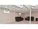 Finished basement with carpet flooring, exposed ceiling, and comfortable seating areas with neutral colors at 1702 Kessler Blvd E Dr, Indianapolis, IN 46220
