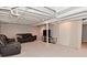 Finished basement with carpet, exposed ceiling, comfortable seating, and entertainment setup at 1702 Kessler Blvd E Dr, Indianapolis, IN 46220