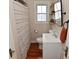 Cozy bathroom with striped shower curtain, vanity and wood flooring at 1702 Kessler Blvd E Dr, Indianapolis, IN 46220