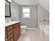 Neutral bathroom featuring a single vanity, toilet, and built in soaking tub at 1702 Kessler Blvd E Dr, Indianapolis, IN 46220