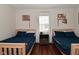 Bedroom featuring twin beds, natural light, and hardwood floors at 1702 Kessler Blvd E Dr, Indianapolis, IN 46220