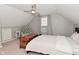 Upstairs bedroom features a ceiling fan, neutral color walls, and a cozy seating area at 1702 Kessler Blvd E Dr, Indianapolis, IN 46220