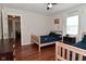 Bedroom view with two twin beds, ceiling fan, and hardwood flooring at 1702 Kessler Blvd E Dr, Indianapolis, IN 46220