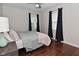 This bedroom features hardwood floors, natural light, and neutral walls at 1702 Kessler Blvd E Dr, Indianapolis, IN 46220