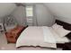 Upstairs bedroom with neutral color walls, ceiling fan, and a cozy seating area at 1702 Kessler Blvd E Dr, Indianapolis, IN 46220