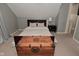 Bright bedroom featuring neutral walls and carpeting, complemented by a stylish trunk accent at 1702 Kessler Blvd E Dr, Indianapolis, IN 46220