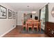 Open dining area with wood table, decor, and view of the entry at 1702 Kessler Blvd E Dr, Indianapolis, IN 46220