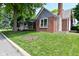 Charming home with a manicured lawn and traditional architectural details at 1702 Kessler Blvd E Dr, Indianapolis, IN 46220
