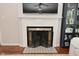 Close-up of fireplace with black metal screen and white mantel at 1702 Kessler Blvd E Dr, Indianapolis, IN 46220