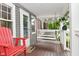 Relaxing front porch with porch swing and Adirondack chairs offers a tranquil outdoor space at 1702 Kessler Blvd E Dr, Indianapolis, IN 46220