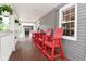 Spacious front porch with comfortable Adirondack chairs and table for outdoor seating at 1702 Kessler Blvd E Dr, Indianapolis, IN 46220