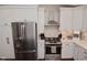 Contemporary kitchen features stainless steel appliances, white cabinets, and modern countertops at 1702 Kessler Blvd E Dr, Indianapolis, IN 46220