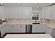 Bright kitchen featuring modern stainless steel appliances, white cabinets and quartz countertops at 1702 Kessler Blvd E Dr, Indianapolis, IN 46220