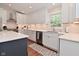 Modern kitchen with stainless steel appliances and a large island with seating and quartz countertops at 1702 Kessler Blvd E Dr, Indianapolis, IN 46220