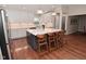 Modern kitchen with a large island with seating, stainless steel appliances, and white cabinets at 1702 Kessler Blvd E Dr, Indianapolis, IN 46220