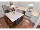 Bright kitchen featuring modern stainless steel appliances, white cabinets, island with seating, and quartz countertops at 1702 Kessler Blvd E Dr, Indianapolis, IN 46220