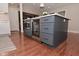Kitchen island featuring a built-in microwave, beverage fridge, and convenient storage drawers at 1702 Kessler Blvd E Dr, Indianapolis, IN 46220