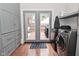 Bright laundry room with built-in storage and stainless steel washer dryer with deck access at 1702 Kessler Blvd E Dr, Indianapolis, IN 46220