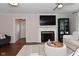 Cozy living room with a fireplace, television, and modern shelving at 1702 Kessler Blvd E Dr, Indianapolis, IN 46220