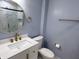 A modern bathroom is outfitted with a white vanity, gold hardware, and a walk-in shower at 1818 Broadway St, Anderson, IN 46012