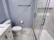 A modern bathroom showcases gold hardware, a walk-in shower, and a toilet at 1818 Broadway St, Anderson, IN 46012