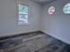 A well-lit bedroom shows two modern style octagon-shaped windows and luxury vinyl plank flooring at 1818 Broadway St, Anderson, IN 46012